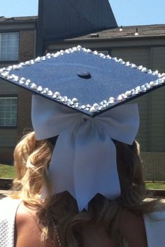 a woman wearing a graduation cap with pearls on it