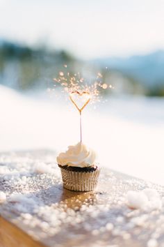 a cupcake with a sparkler sticking out of it