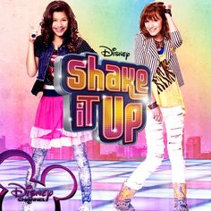 two girls standing next to each other in front of a sign that says shake it up