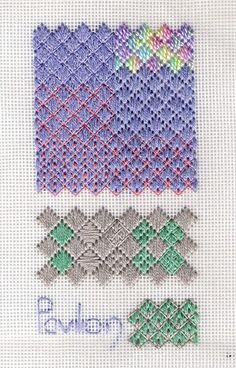 some cross stitch designs on a white cloth