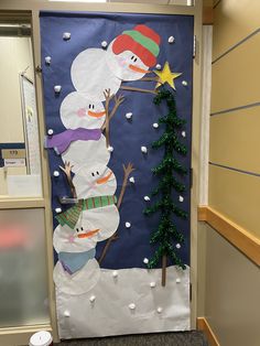 a door decorated with snowmen and a christmas tree