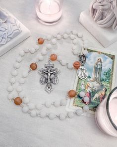 Discover the serene beauty of our Matte White Fatima Rosary, designed to inspire and uplift your prayer life. This stunning rosary features smooth matte white jade beads that evoke purity and tranquility, making it a perfect companion for meditation and reflection. At the heart of the rosary is a unique Terra from Fatima center, symbolizing the deep spiritual connection to Our Lady of Fatima and her powerful messages. The Our Father beads depict the Aparitian of Our Lady at Fatima as well as ima Powerful Messages, Prayer Life, Lady Of Fatima, White And Beige, Our Father, The Rosary, Spiritual Connection, Jade Beads, White Beads