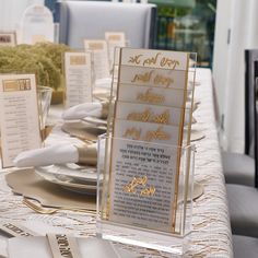 the table is set with silver and gold place settings