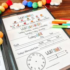 a close up of a paper on a table with markers and crayons around it