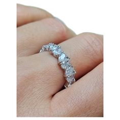 a woman's hand with a wedding ring on it, showing the diamond band