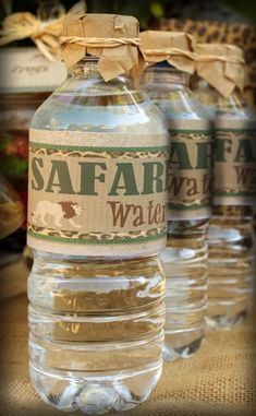 two water bottles with labels on them sitting next to each other in front of some food