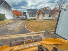 a yellow truck parked in front of a house