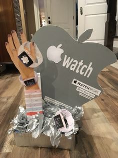 an apple watch display in a box on the floor next to some other items that have been wrapped around it