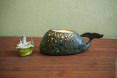 a tea light holder sitting on top of a wooden table