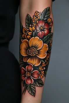 a woman's arm with an orange and red flower tattoo on her left arm