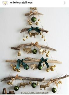 a christmas tree made out of driftwood with ornaments hanging from it's sides