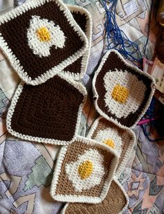 three crocheted coasters with an eagle on them sitting on a quilted surface