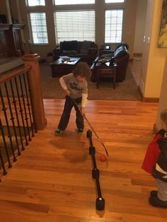 two young boys playing with their toys in the living room