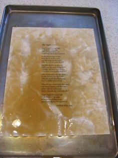 a cookie sheet with writing on it sitting on top of a counter next to a pan