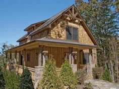 a small wooden house sitting on top of a lush green hillside