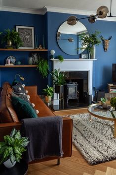 a living room filled with furniture and a fire place next to a mirror on the wall