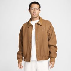 We channeled old-school varsity vibes with this heavyweight wool classic. Built with the same painstaking detail as the vintage ones, it has diamond quilting inside, real-leather trim and a roomy fit perfect for layering. Wool Varsity Jacket With Ribbed Collar For Streetwear, Classic Wool Varsity Jacket, Classic Wool Varsity Jacket With Ribbed Collar, Classic Brown Varsity Jacket For Fall, Classic Brown Winter Varsity Jacket, Classic Brown Long Sleeve Varsity Jacket, Nike Winter Outerwear For College, Classic Outerwear With Corduroy Collar For Streetwear, Classic Wool Outerwear For College