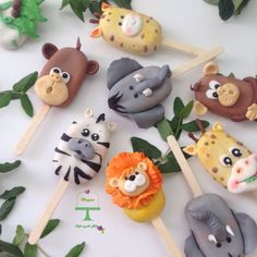 there are many different animal lollipops on the stick with leaves around them