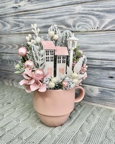 a pink coffee cup filled with flowers and decorations