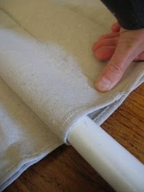 a person is holding the edge of a piece of cloth on top of a table