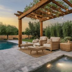 an outdoor living area next to a swimming pool with seating and lights on the pergoline