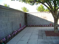 the memorial wall is decorated with american flags