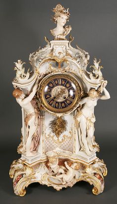 an ornate clock with cherubs and angels on it