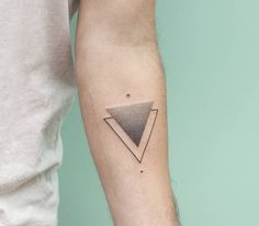 a man's arm with a tattoo on it that is shaped like a triangle