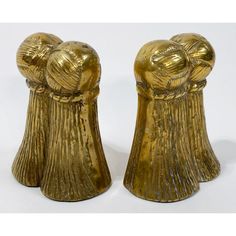 two gold colored vases that are shaped like boxing gloves