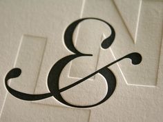 the letter b is made up of black and white paper with an arrow on it