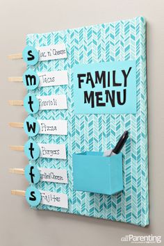 a blue and white wall mounted on the side of a wooden board with magnets attached to it