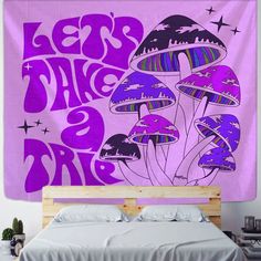 a purple wall hanging over a bed in a bedroom