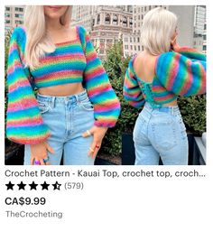 a woman with blonde hair wearing blue jeans and a rainbow striped cropped sweater, standing in front of a cityscape