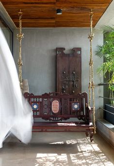 a wooden swing sitting next to a window