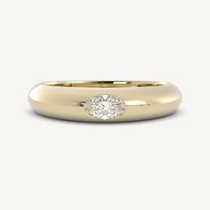 a yellow gold ring with a round diamond in the center