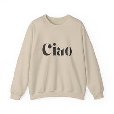 Stay warm and stylish with the Ciao Sweatshirt! The ribbed collar and medium-heavy fabric blend of cotton and polyester provide ultimate coziness. No more itchy side seams, thanks to the tear-away label. Available in sand, gray, or white from Gildan. Made using 100% ethically grown US cotton. Gildan is also a proud member of the US Cotton Trust Protocol ensuring ethical and sustainable means of production. The blank shirt's dyes are OEKO-TEX-certified dyes with low environmental impact. Fabric b Oversized Beige Letter Print Sweater, Oversized Beige Sweater With Letter Print, Beige Cotton Sweater With Letter Print, Beige Ribbed Collar Sweatshirt For Winter, Trendy Beige Sweatshirt Relaxed Fit, Oversized Beige Crew Neck Sweatshirt, Relaxed Fit Cream Sweater With Letter Print, Trendy Beige Relaxed Fit Sweatshirt, Beige Relaxed Fit Trendy Sweatshirt