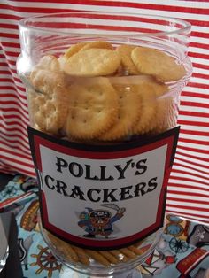 a glass container filled with crackers on top of a table