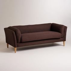 a brown couch sitting on top of a white floor