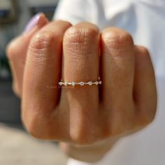 a woman's hand with a diamond ring on it