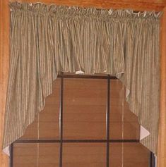 an open window with curtains and blinds on the outside, in front of a wooden wall