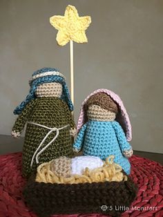 two crocheted nativity figurines sitting on top of a basket