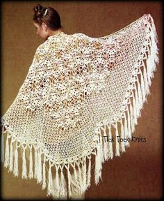 a woman wearing a white crocheted shawl