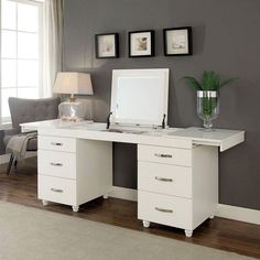 a white desk with two drawers and a mirror