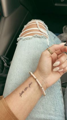 a woman's arm with a small tattoo on it that says, thank you