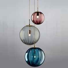 three colorful glass balls hanging from a ceiling