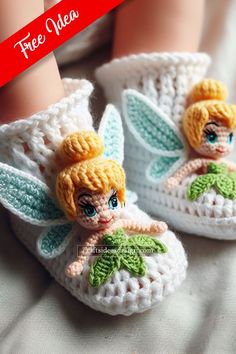 a crocheted doll is sitting on top of a pair of white slippers