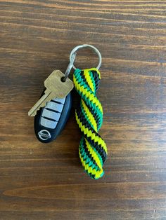 a keychain with a yellow and black stripe on it