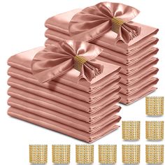 a stack of pink napkins with gold bows on top and six smaller ones in the middle