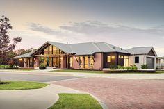 a large house with lots of windows on the side of it's front yard