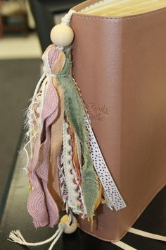 a book with a tassel on it sitting on a table next to a chair